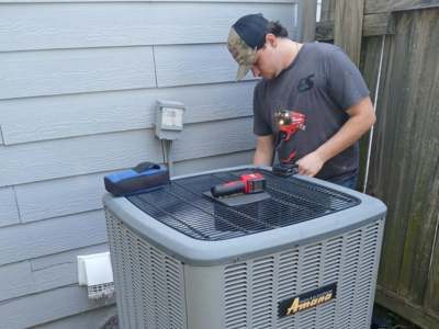 Engle Services HVAC Technician repairing an AC unit in Birmingham, Alabama
