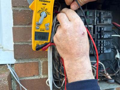 Engle Services electrician working on an electrical panel in Birmingham, AL